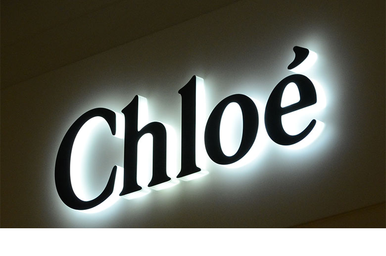 Custom business logo with illuminated acrylic edges and a solid front face