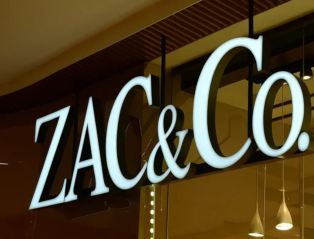 Custom front-lit business letters glowing above an American storefront